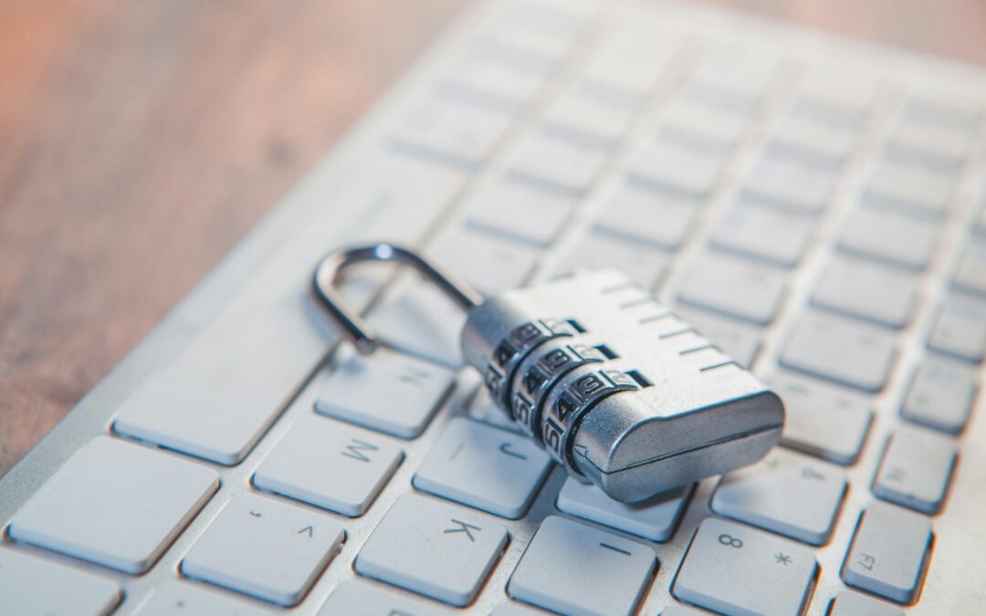 A combination lock rests on a computer keyboard.